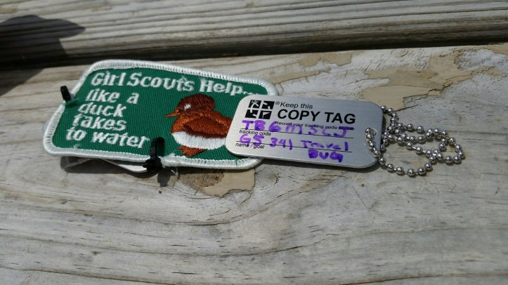 Travel bug example for Girl Scout Junior Geocaching Badge. This one uses an old program patch to attach to the travel bug.